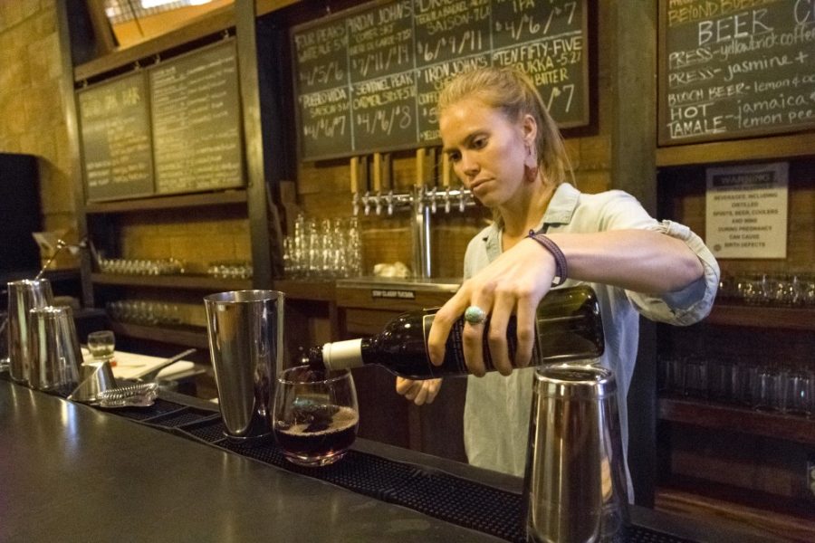 Bartender Alina Mouritsen pours a glass of wine at Unplugged Bar and Wine on Wednesday, Sept. 30. Mouritsen has bartended for eight months after working in the food industry.