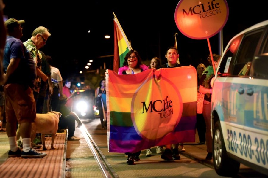 People march along Fourth Avenue during Pride on Parade on Saturday, Oct. 10, carrying banners in support of LGBTQ rights. The parade has been a mainstay for the Tucson Pride Week since 2000, and serves the purpose of giving those in the LGBTQ community a public stage to be proud of who they are. 