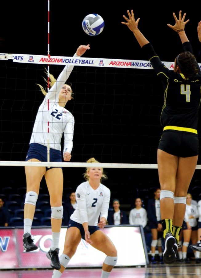 Arizona hitter Nikki Attea (22) spikes against Oregon in McKale Center on Sunday, Sept. 27. Attea will face old friend Jordan Anderson of UCLA this weekend.