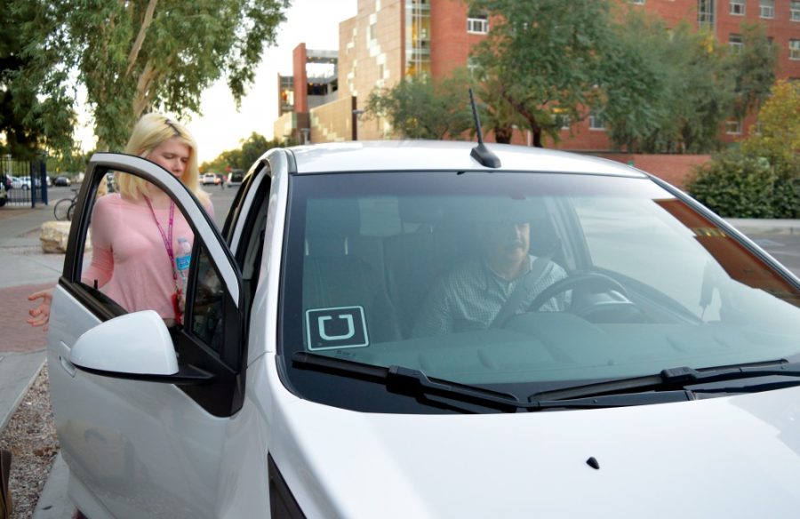 Uber driver Plutarco Padilla picks up a student outside of Park Student Union on Nov. 9. A recent assault by an imposter Uber driver has prompted an investigation by the Tucson Police Department. A UAPD officer and an Uber spokeswoman urge customers to be safe when it comes to public transportation. 