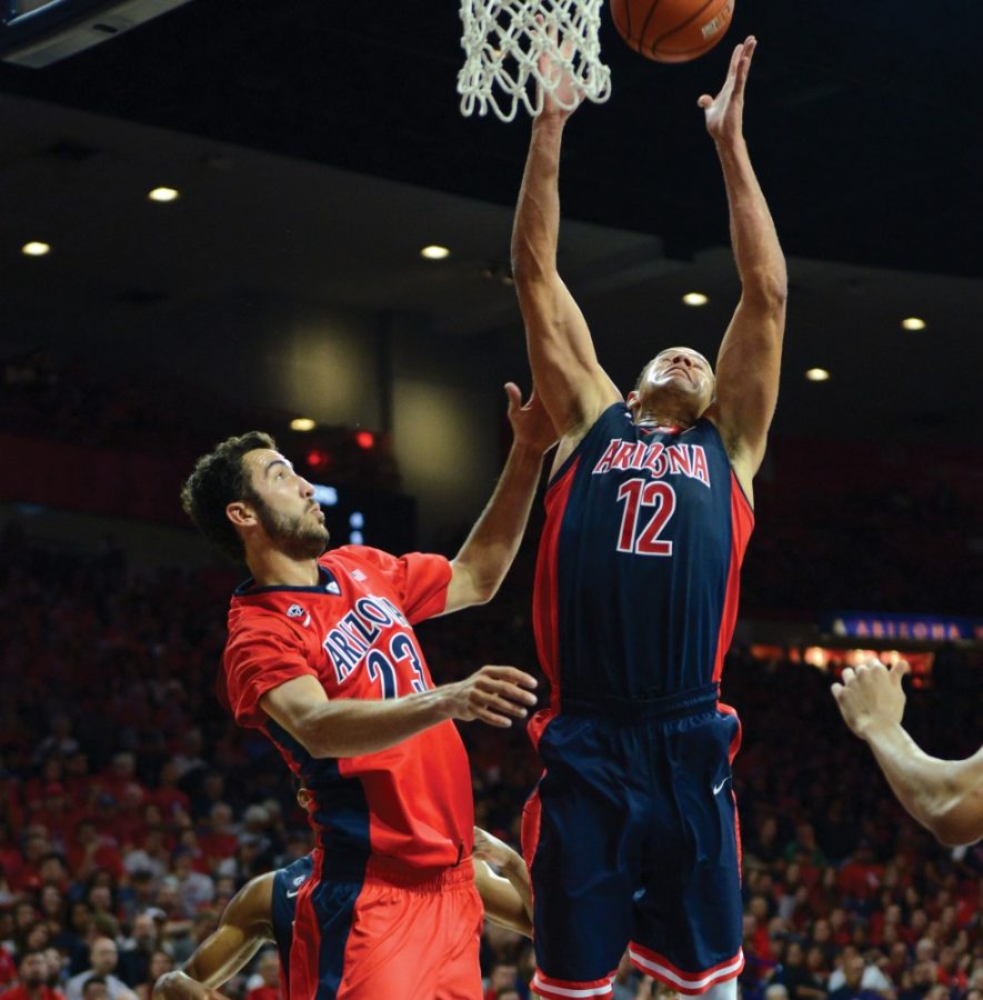 Arizona forward Ryan Anderson (12) leaps for the rebound despite forward Mark Tollefsens (23) defense in McKale Center during the 2015 Red-Blue Game on Oct. 17. Anderson finished the scrimmage with 15 points and eight rebounds in 20 minutes of action.