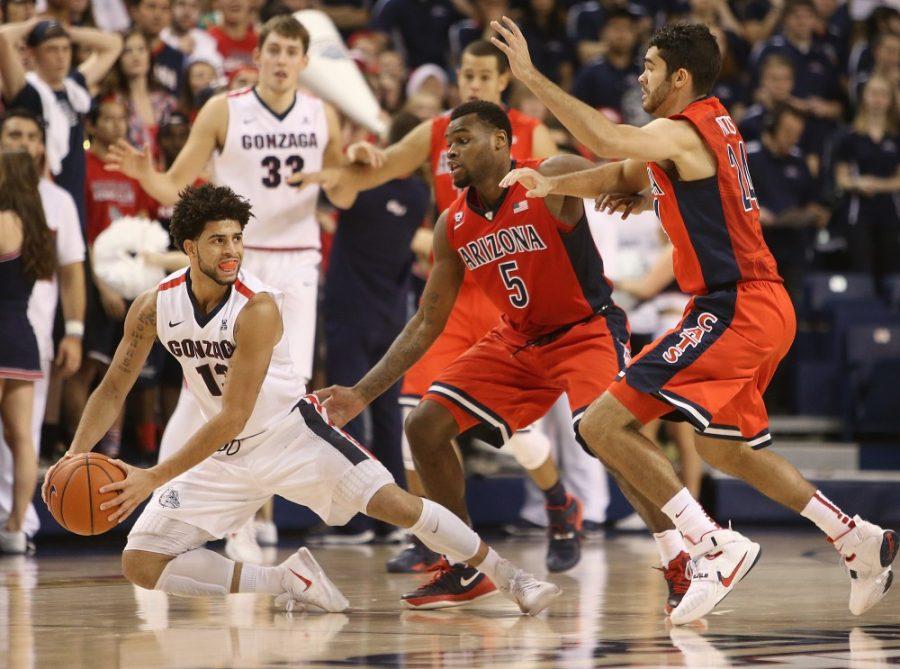 Gonzaga Bulldogs guard Josh Perkins (13) gets tripped up in the pressure defense of Arizona Wildcats guard Kadeem Allen (5) and Arizona Wildcats guard Elliott Pitts (24) during the second half of the No. 19 Arizona Wildcats vs. No. 13 Gonzaga Bulldogs mens NCAA college basketball game at McCarthey Athletic Center in Spokane, Wash. Arizona used a second-half comeback to win 68-63.
Photo taken Saturday, Dec. 5, 2015.
Mike Christy / Arizona Daily Star