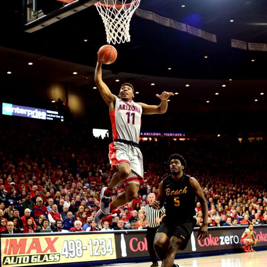 Arizona guard Allonzo Trier (11) jumps over a Long Beach State player in McKale Center on Tuesday, Dec. 22. Arizona defeated Long Beach State 85-70.