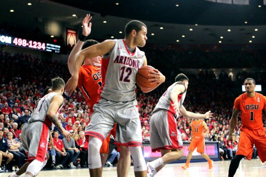 Arizona guard Ryan Anderson (12) wards off an Oregon State player in McKale Center on Saturday, Jan. 30. The Wildcats won 80-63.