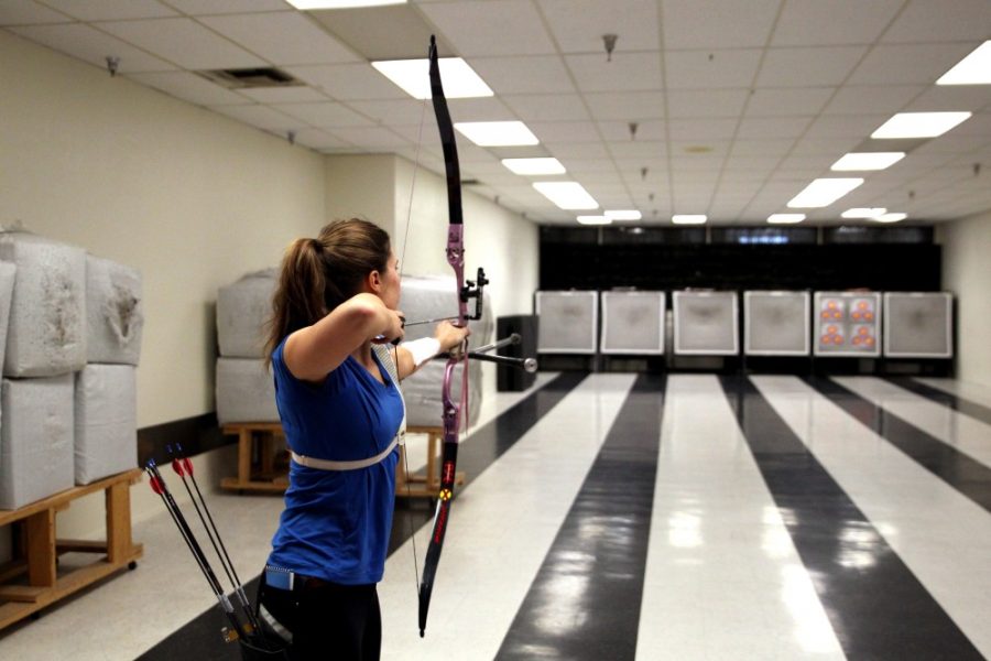 Madison Eich aims down range on Saturday, Jan. 30 at PSE Archery, a range and pro-shop located on Fairview Avenue and Glenn Street. Eich, an Olympic hopeful, is a member of the Wildcat Archery club.