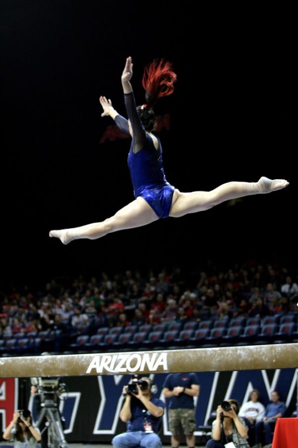 Arizona gymnast Shelby Edwards performs a mid-air splits in McKale Center on Saturday, Feb. 13.