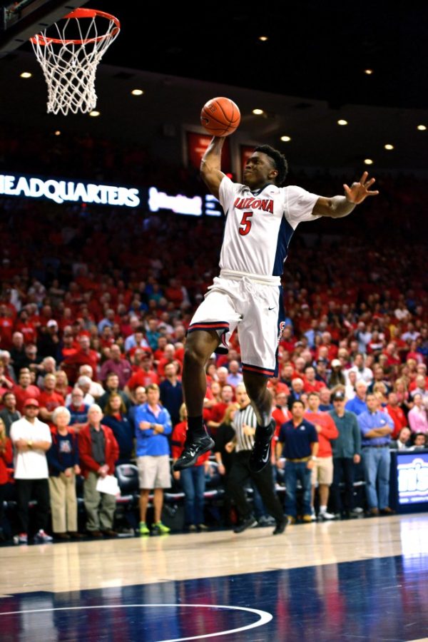 Former Arizona forward Stanley Johnson (5) takes off for a dunk against USC in McKale Center on Feb. 19, 2015. Johnson is making a name for himself as part of the Detroit Pistons and currently averages nine points per game. 
