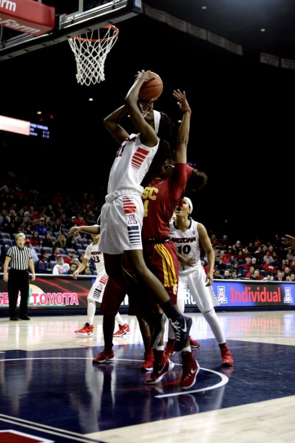 Arizona forward Destiny Graham (21) jumps to put in 2 points after grabbing a rebound against USC on Friday, Feb. 5.