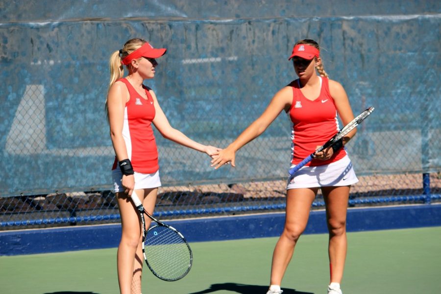 Arizona womens tennis athletes Lauren Marker and Shayne Austin high five during their 6-4 win against the University of San Diego on Feb. 12. The Wildcats lost their perfect at home record with a 5-2 loss against Stanford.