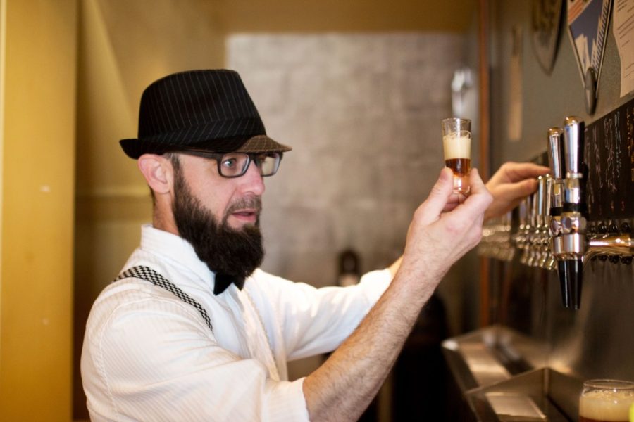 Casa Film Bar bartender Ty Young inspects freshly tapped beer on March 10.  