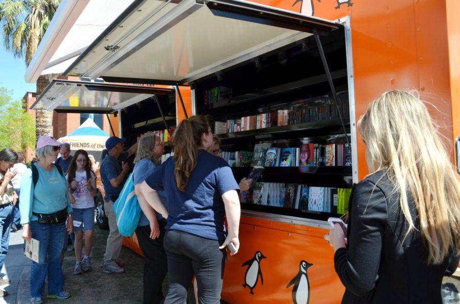 Festivalgoers browse the Penguin Book Trucks selection at the Festival of Books on the UA Mall on Saturday, March 15, 2014. The Festival of Books will run on the UA Mall from Saturday to Sunday and offers a wide variety of interesting activities and events.