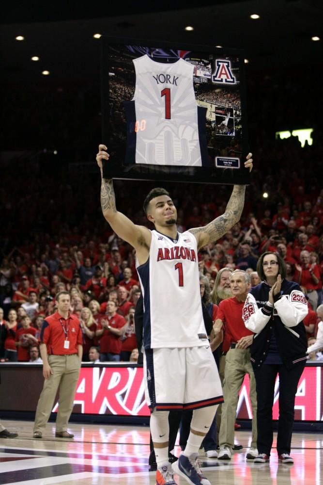 Arizona guard Gabe York (1) holds up his framed jersey during Arizona’s senior night on March 5 in McKale Center. York scored 32 points during his final game in McKale Center.