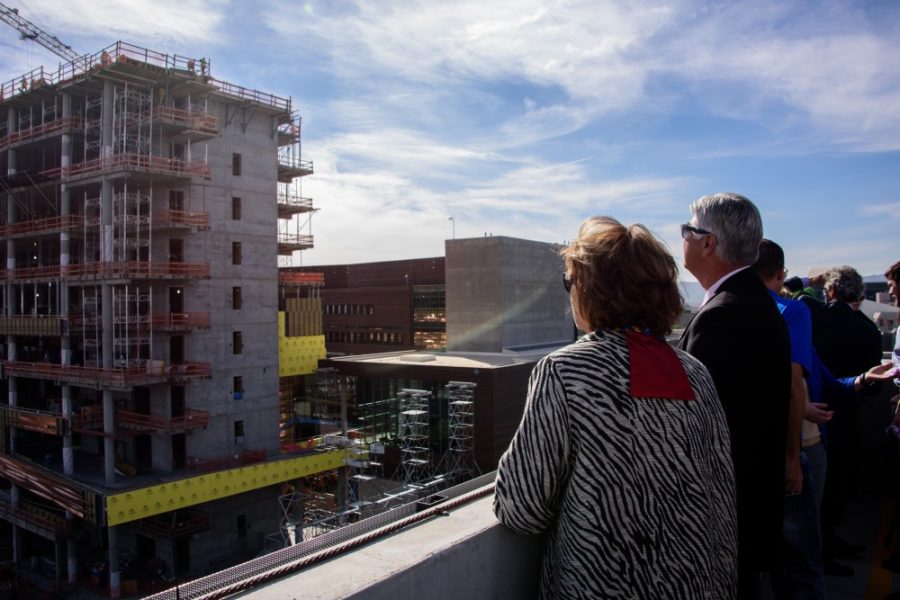  UA President Ann Weaver Hart and Joe G.N. “Skip” Garcia, MD, Senior Vice President of UA Health Sciences watch as top beam is placed on the Biomedical Partnership building in Phoenix on March 3, 2016.