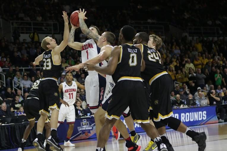 Gabe York attempts a shot through Wichita States swarming defense in Arizonas first-round loss in Providence, Rhode Island on Thursday, March 17.