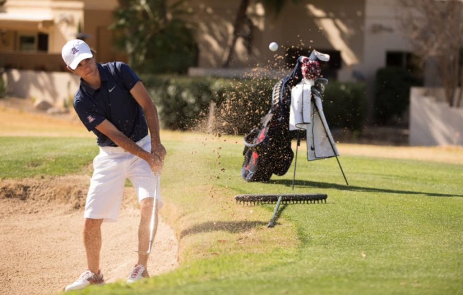 Arizona golf athlete Ari Gulugian blasts out of the bunker during National Invitational Tournament in Tucson, Ariz.