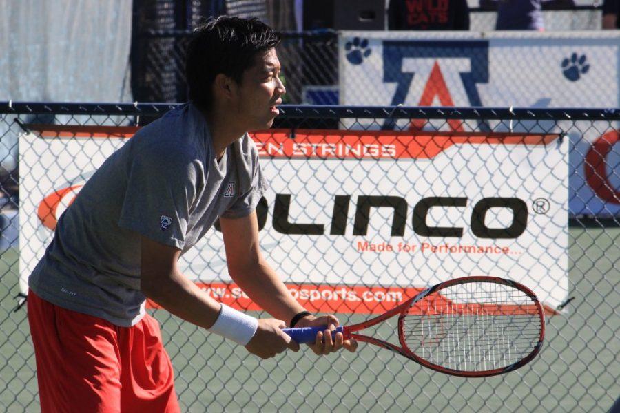 Arizona athlete Naoki Takeda prepares for his first match against NAU in Tucson on Feb. 13, 2016.The UA mens team won with a team score of 5-2.