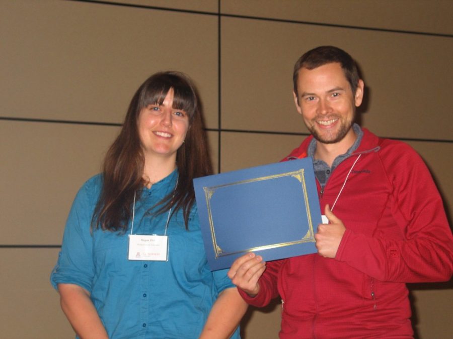 Megan Zivic, a representative of Montgomery and Associates, presents the award for best overall talk to Luke Parsons. Parsons and other geosciences researchers presented their work last week at the 44th Annual Geodaze Symposium.
