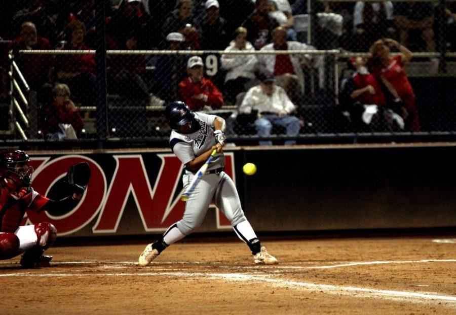 Arizona outfielder Katiyana Mauga (34) hits deep into the outfield, bringing teammate Mandi Perez (55) home at Hillenbrand Stadium on Friday, March 25. The Wildcats are headed into the final stretch of the regular season. 
