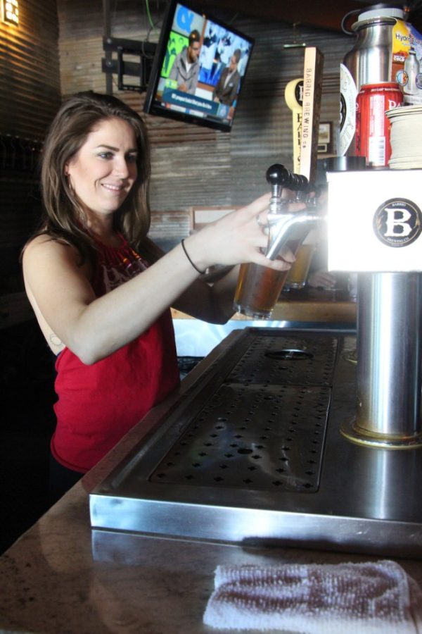 Bartender Sarah Cutlip making drinks for her customers at Barrio Brewing Co., located at 800 E. 16th St., on Friday, April 15. Cutlip enjoys serving customers in a bar downtown.