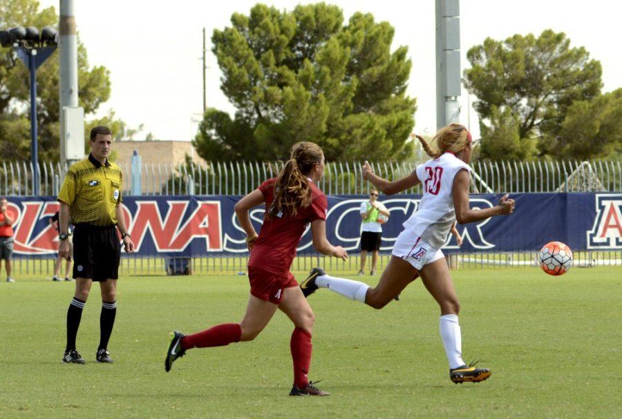 Arizona defender Alexa Montgomery (20) runs past a Stanford University athlete and kicks the ball downfield in Tucson on Oct. 4, 2015. The Wildcats will look to finish their spring season on a high note. 
