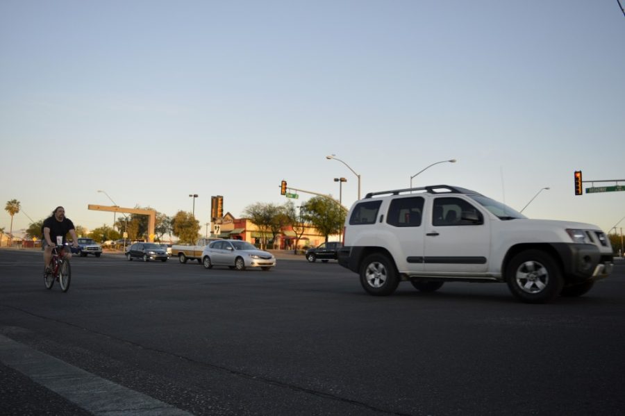 Vehicles and a bicyclists travel west at the intersection of Broadway and Euclid. 