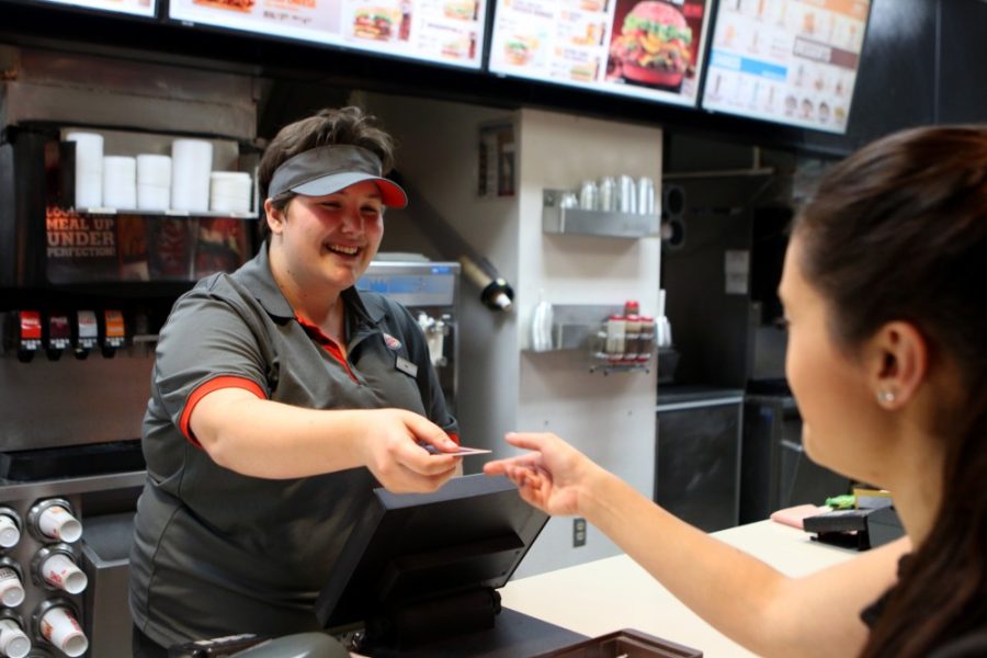 Burger King employee returns a customer’s CatCard on Monday, April 4. 