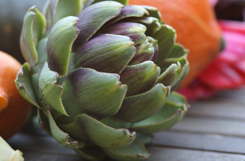 An+artichoke+lies+on+a+table.+Garlic-roasted+artichokes+make+for+a+great+summer+treat+and+are+simple+to+make.