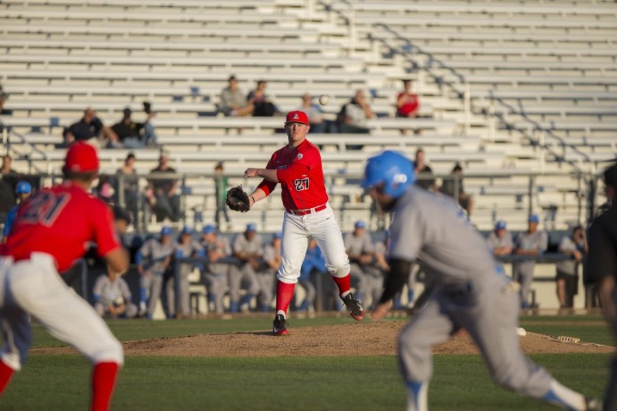 Arizona pitcher JC Cloney (21) throws to first to catch a UCLA player on Thursday, March 24. Cloney and the UA starters found success against Utah, but a bullpen struggle led to the Wildcats being swept. 