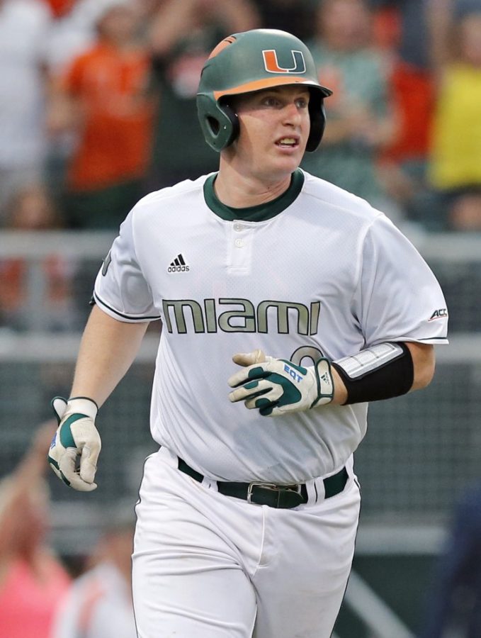 Miami’s Zack Collins watches the ball after hitting a three-run home run in the third inning against Boston College in the opener of the NCAA Tournament’s Coral Gables Super Regional at Alex Rodriguez Park at Mark Light Field in Coral Gables, Fla., on Friday, June 10, 2016. (Al Diaz/Miami Herald/TNS)