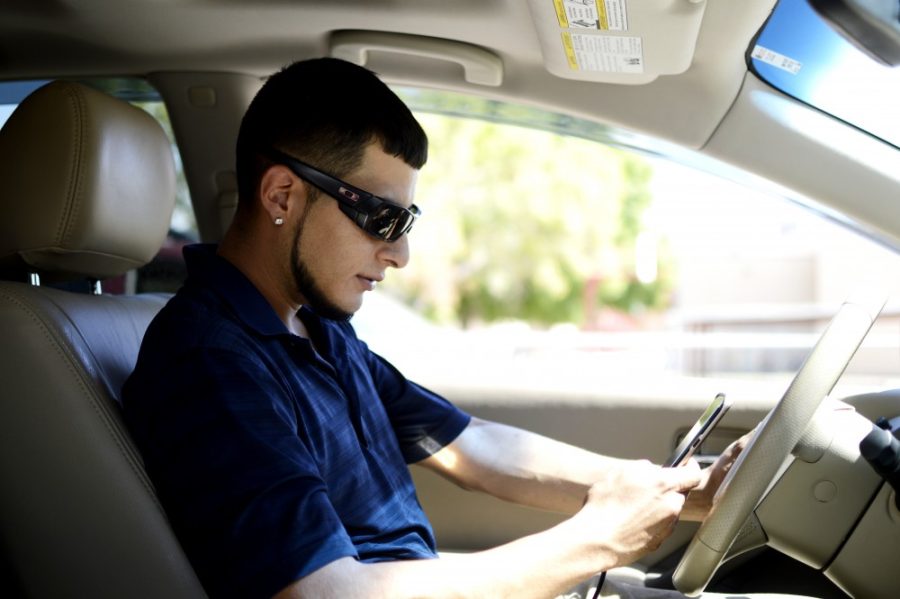 22 year old Alder Jimarez texts while driving home on Monday, July 25 afternoon after work.