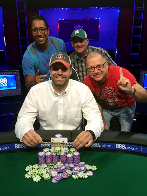 UA finance professor Mitch Towner (center) poses for a photo with Nick Adamakis (right), Clyne Namuo (left) and a fan (back center) with Towners winnings during the World Series of Poker in Las Vegas, Nevada. Towner won over $1 million in the Monster Stack No-Limit Holdem tournament.