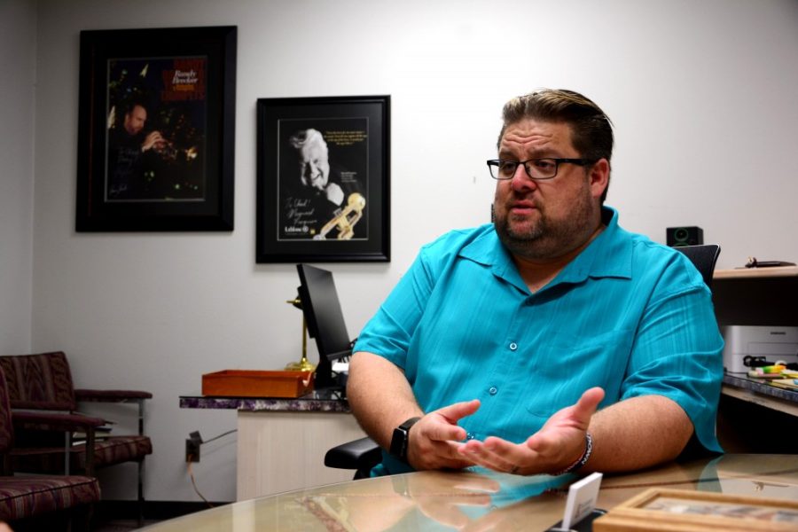 Chad Shoopman, the newly appointed Assosciate Director of Bands and Director of Athletic Bands, discusses his musical career in his office in the Music Building on Aug. 3, 2016. Shoopman hopes to bring more pride to the Pride of Arizona by focusing on five key factors: perform, respect, integrity and discipline.