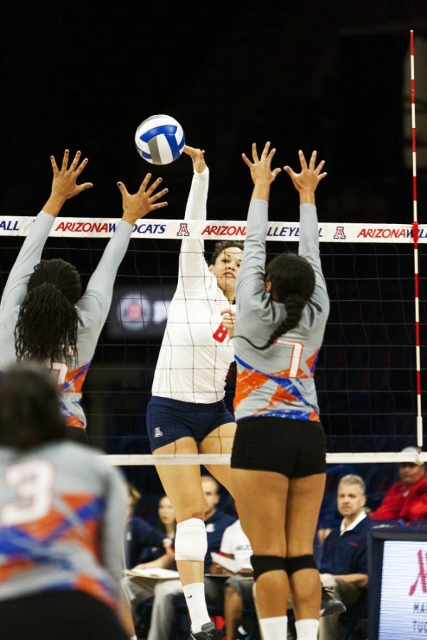 Arizona volleyball outside hitter Kendra Dahlke spikes the ball past two Savannah State players on Sept. 19, 2015.