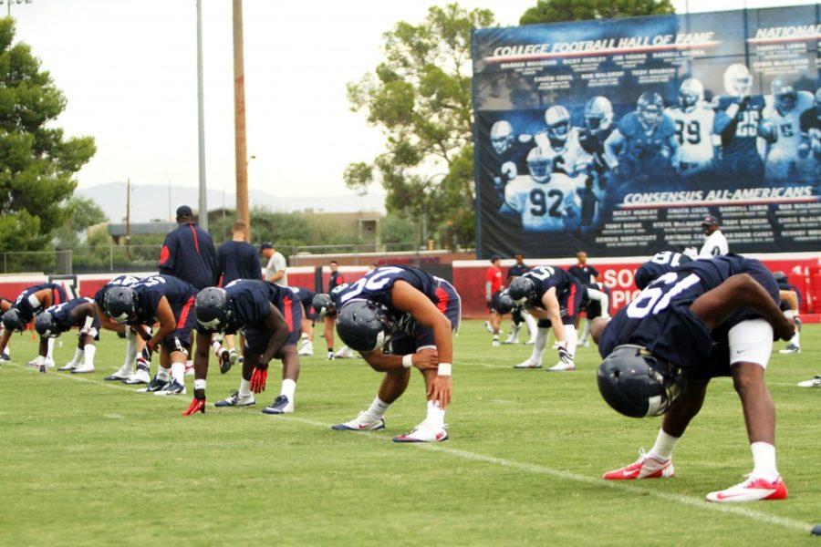 Arizona football athletes stretch before practice on Friday, Aug. 5.