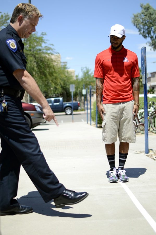 Criminal justice junior Marcus Tutoatasi performs a sobriety test for UAPD Officer George Eppley on Friday, Aug. 19. Officer Eppley used to work for the Tucson DUI unit for the city of Tucson, in which he made over 7,200 DUI Arrests.