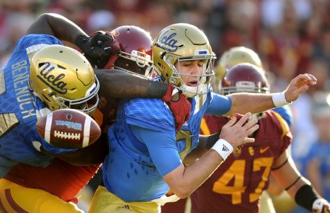 USC&apos;s Claude Pelon forces UCLA quarterback Josh Rosen, middle, to fumble in the third quarter, recovered by USC&apos;s Rasheem Green and returned for a touchdown, at the Los Angeles Coliseum on Saturday, Nov. 28, 2015, in Los Angeles. USC won, 40-21. (Wally Skalij/Los Angeles Times/TNS)