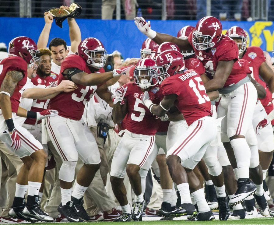 Alabama defensive back Cyrus Jones (5) is mobbed by teammates after intercepting a pass in the end zone late in the first half against Michigan State in the Goodyear Cotton Bowl at AT&T Stadium in Arlington, Texas, on Thursday, Dec. 31, 2015. (Smiley N. Pool/Dallas Morning News/TNS)