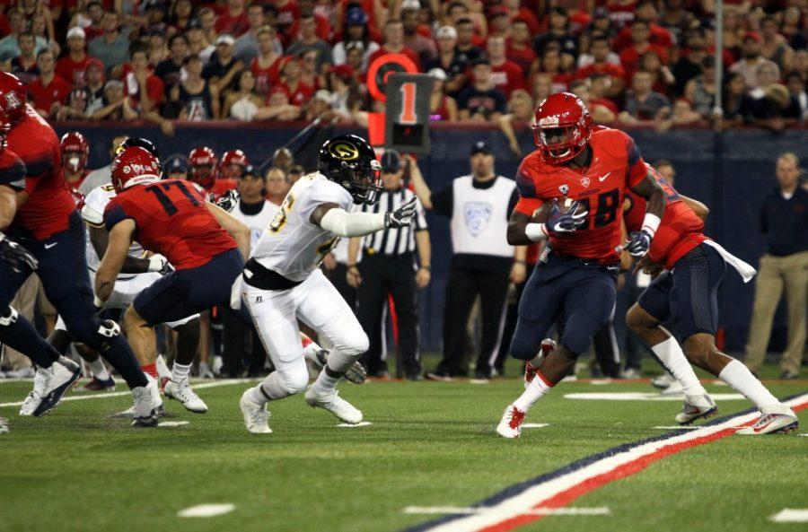 Arizona running back Nick Wilson (28) runs the ball past a Grambling State defender on Saturday, Sept. 10. Arizona won the game 31-21 after trailing 21-3 in the first half.