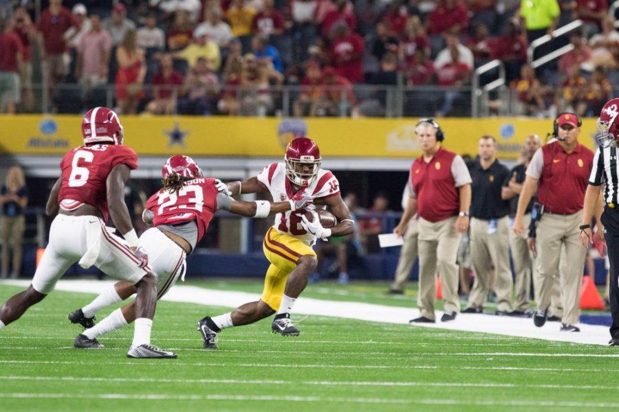 USC quarterback Dominic Davis pushes away Alabama Aaron Robinson as he runs the ball down the field on Saturday, Sept. 3 in Arlington, Texas.