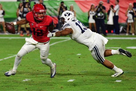 Arizona quarterback Anu Soloman (12) tries to fend off BYU linebacker Francis Bernard (13) during Arizona's 18-16 loss to BYU in the Cactus Kickoff Classic at the University of Phoenix Stadium on Saturday, Sept. 3.