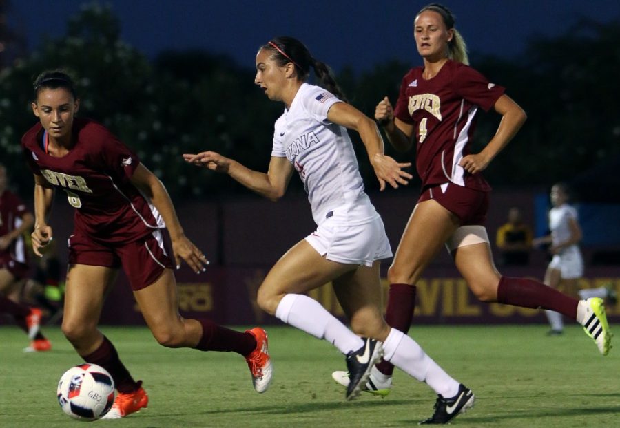 Arizona midfielder Gabi Stoian (9) slips past Denver defenders Cheyenne Shorts (6) and Hannah Bricker (4) at the Sun Devil Desert Classic at Sun Devil Soccer Stadium in Tempe on Friday, Sept. 2, 2016. The Wildcats won the matchup 3-0, one of which was scored by Stoian.