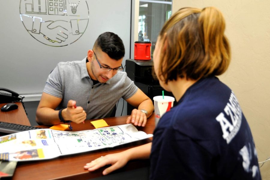 Ramses Sepulveda, a coordinator for academic success and achievement at the Office of Student Engagement, helps a student find the quickest route to her classes on Monday, Aug. 29. Sepulveda says that his favorite thing about his job is passing on everyday campus advice and experiences.