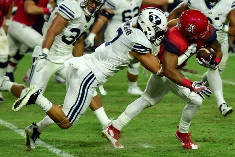 BYU defensive back Micah Hahnemann (7) takes down Arizona offense during Arizona's 18-16 loss to BYU in the Cactus Kickoff Classic at the University of Phoenix Stadium on Saturday, Sept. 3.