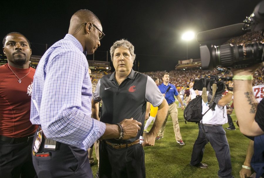 Washington State Cougars head coach Mike Leach, center, is interviewed by media after a 37-32 win over the Arizona State Sun Devils in Sun Devil Stadium, in Tempe, Arizona, on Saturday, Oct. 22, 2016.
