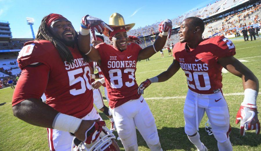 Oklahomas Nick Basquine (83) celebrates with teammates  Arthur McGinnis (50) and Najee Bissoon (20) following the Red River Showdown at the Cotton Bowl in Dallas on Saturday, Oct. 8, 2016. Oklahoma defeated Texas, 45-40. (Ron Jenkins/Fort Worth Star-Telegram/TNS)