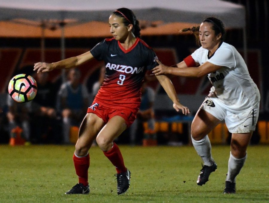 Arizona midfielder Gabi Stoian (9) remains in play while Colorado midfielder Morgan Stanton (6) tries to hold her back at Murphey Field at Mulcahy Soccer Stadium on Thursday, Sept. 29, 2016. The Buffs beat the Wildcats 1-0.