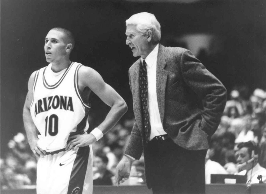 (Courtesy Arizona Athletics) Legendary Arizona basketball head coach Lute Olson (right) talks to Mike Bibby (10). Olson helped hoist the Wildcats to prominence in the college basketball world. 