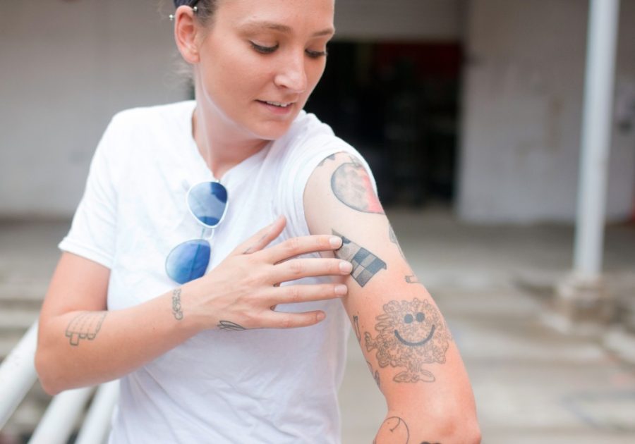 Alissa Neal, a third year grad student in the 3D Extended Media program, shows off her tattoos outside the Art Building on Wednesday, Sept. 28. Neal hopes to express everything she's gone through and wants to go through in life in her tattoos.