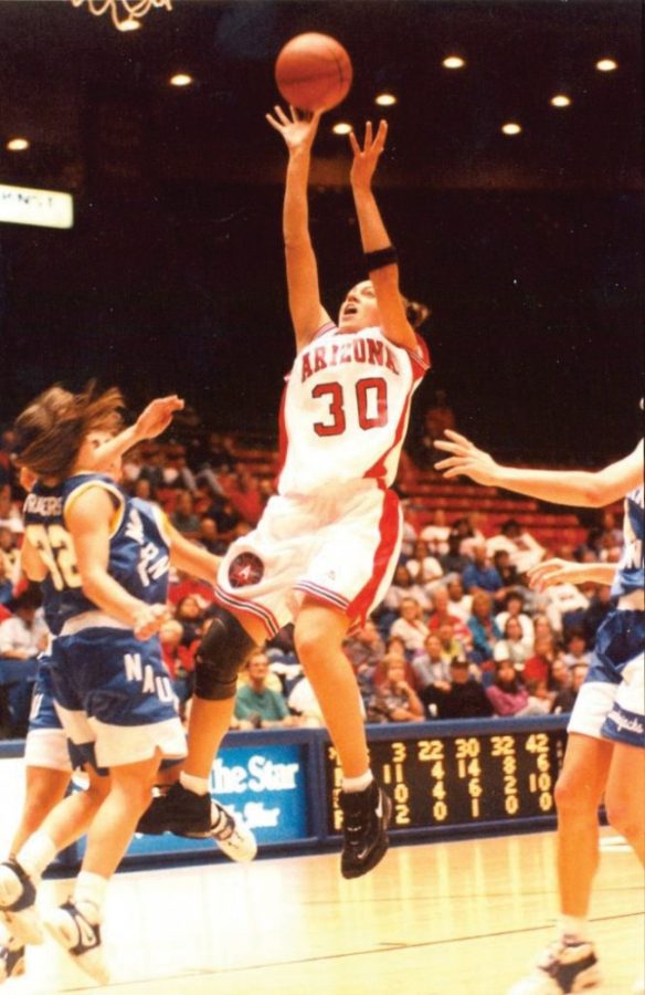 Retired Arizona player Adia Barnes jumps backward while shooting against NAU in McKale Center. 
