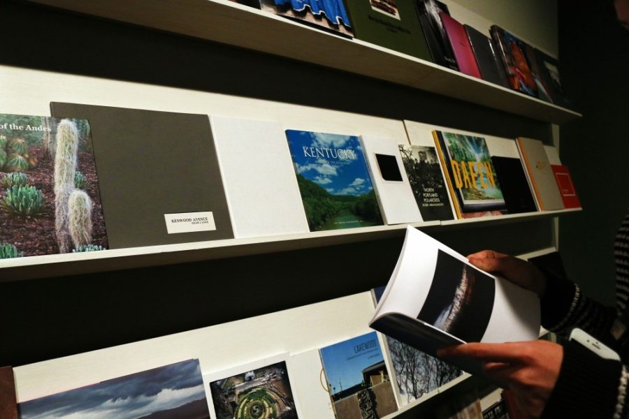 UA student flips through one of the many photobooks assignment on display at the Center for Creative Photography as part of their new exhibit. The INFOCUS Juried Exhibition of Self-Published PhotoBooks will run through Jan. 7.